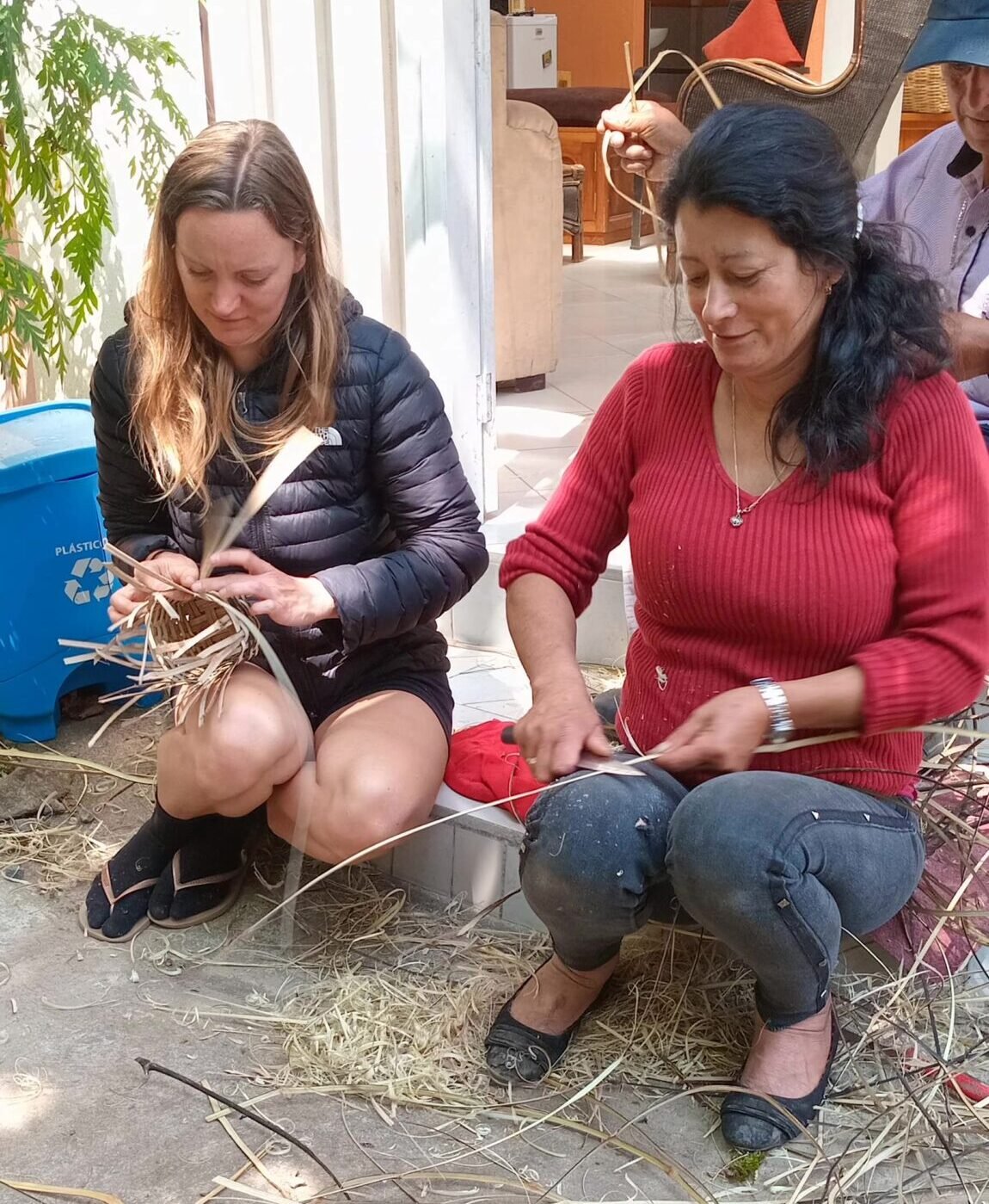 Two ladies weaving baskets